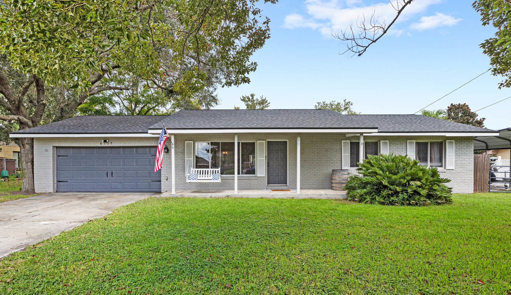 front of one story home with blue garage door and grey brick